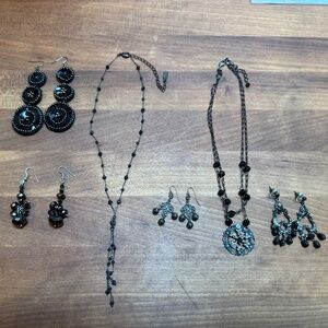 Variety of black beaded necklaces and earrings.